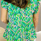 Ruffled Printed Tie Neck Cap Sleeve Blouse