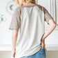 Heimish Full Size Animal Print Half Button Short Sleeve Top