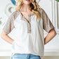 Heimish Full Size Animal Print Half Button Short Sleeve Top