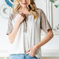 Heimish Full Size Animal Print Half Button Short Sleeve Top